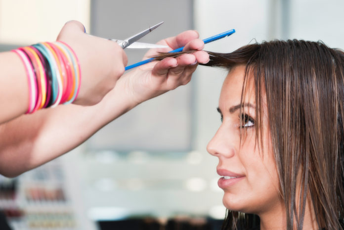 Young woman getting a new haircut at hair salon